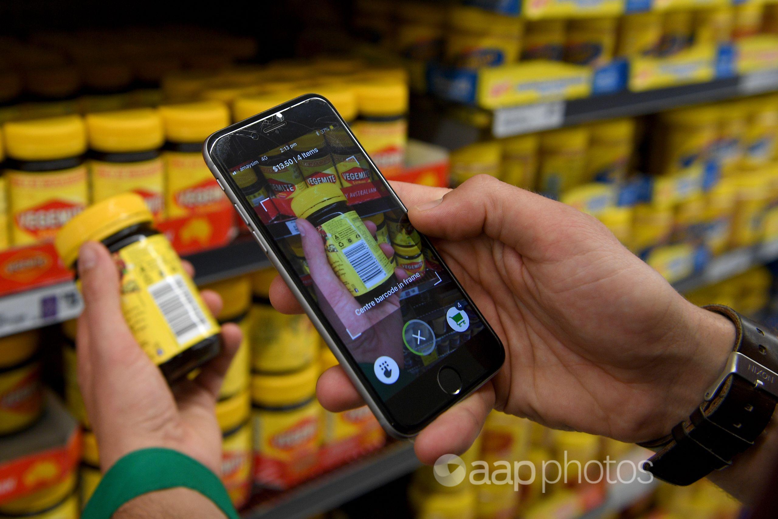 Woolworths' employee uses a new app in Sydney. (AAP/Dan Himbrechts)