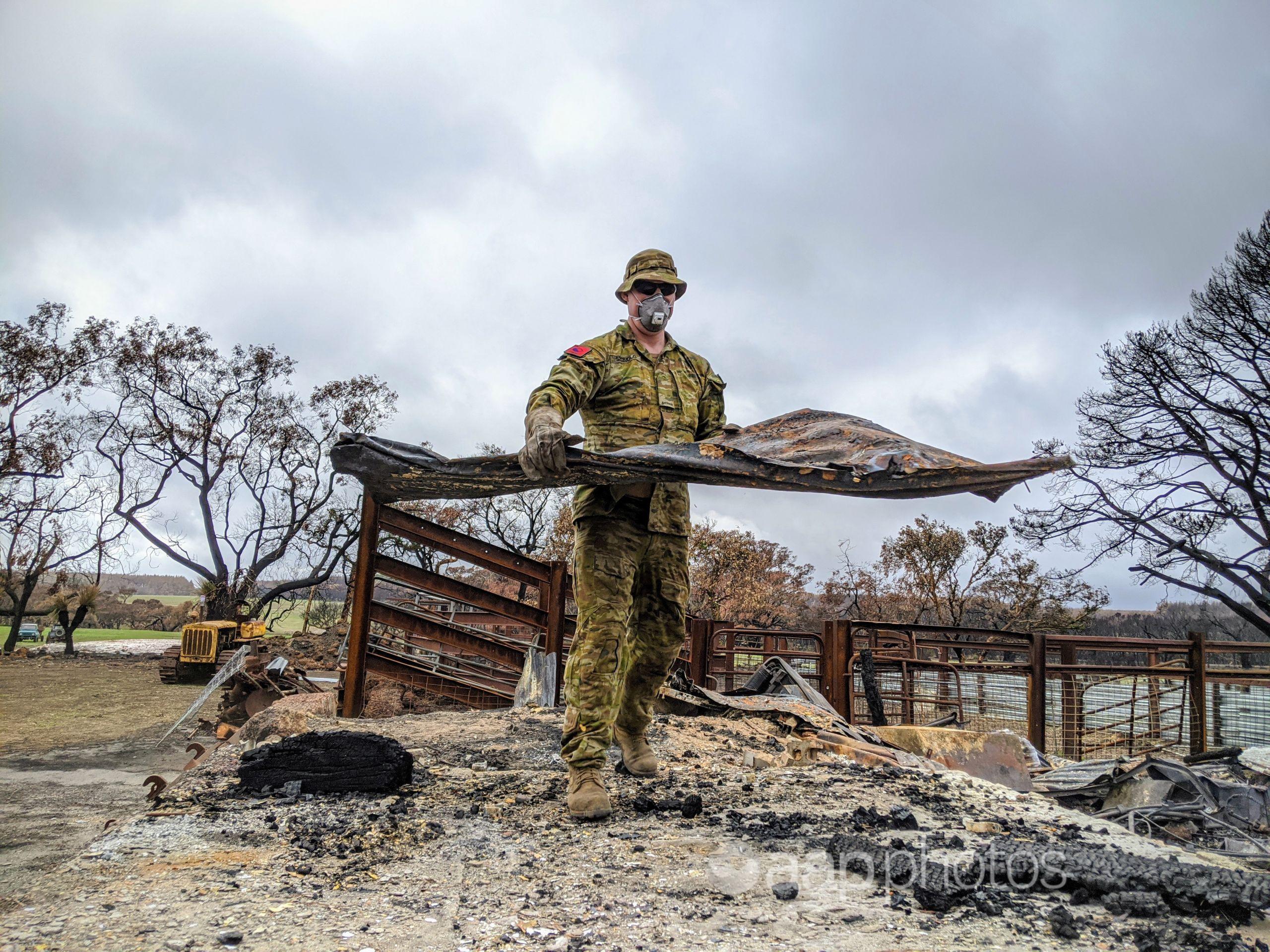 An soldier assisting with a clean-up after fires on Kangaroo Island.