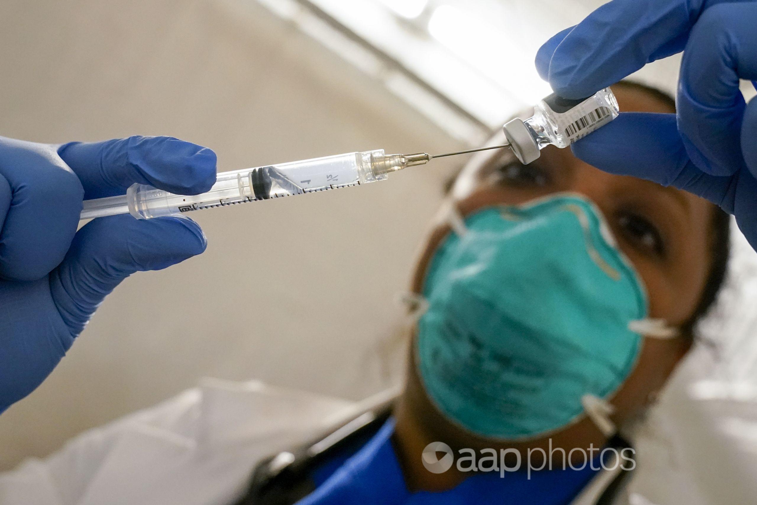 A doctor in New York extracts the Pfizer-BioNTech COVID-19 vaccine.