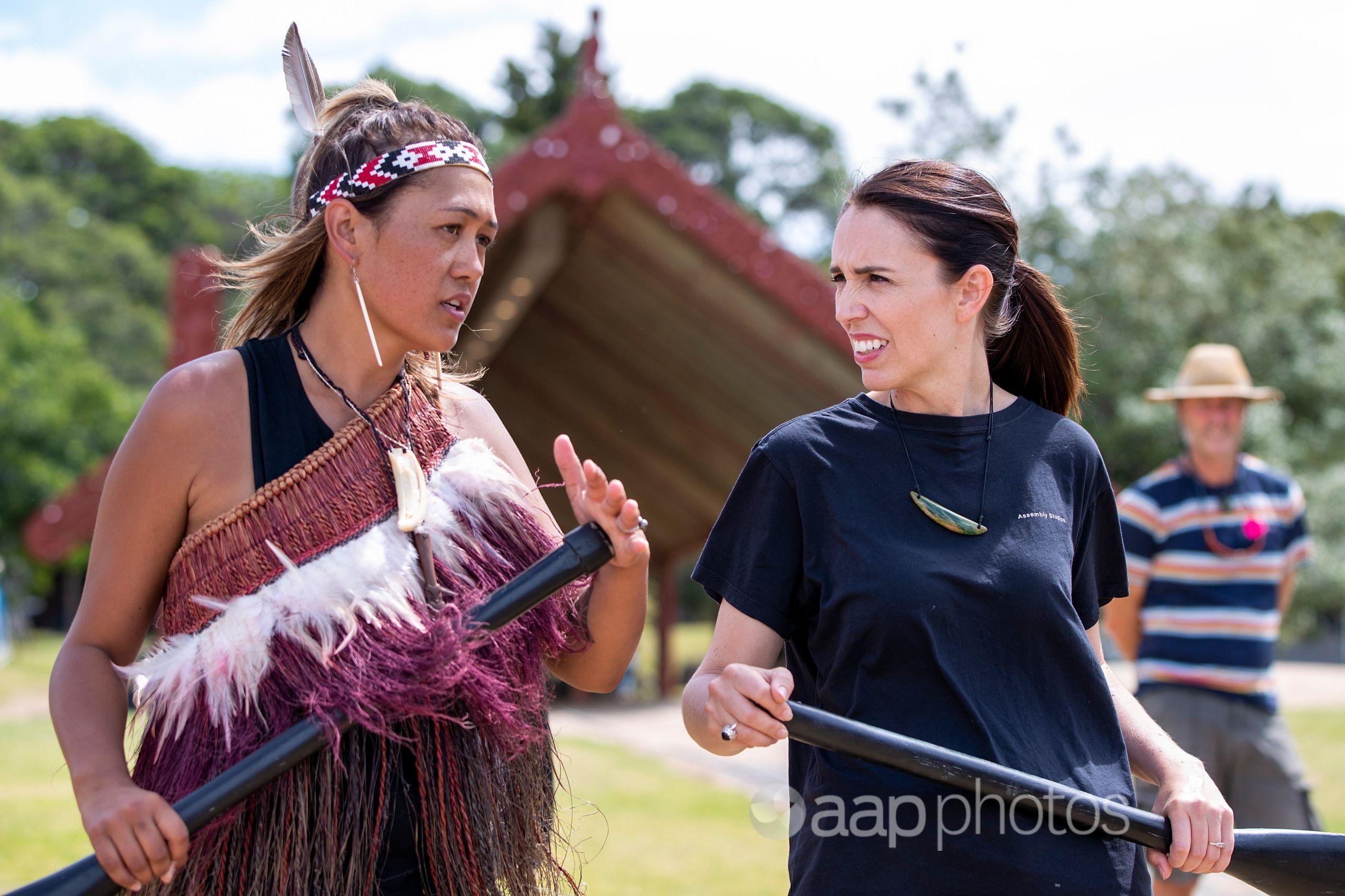 NZ PM Jacinda Ardern talks to a Maori crew member.