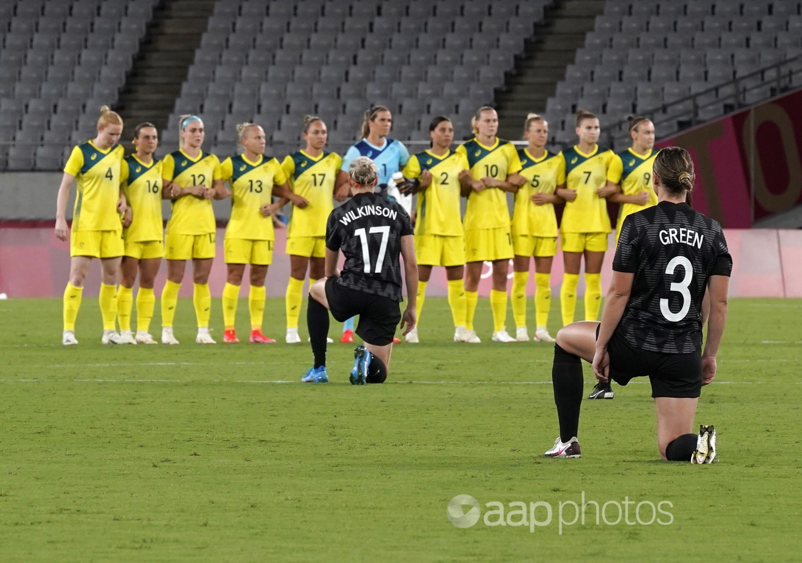 NZ players kneel before the women's soccer match against Australia.