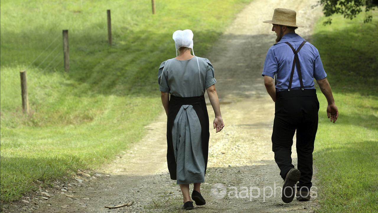 An Amish couple near a farm at Fort Plain, New York.