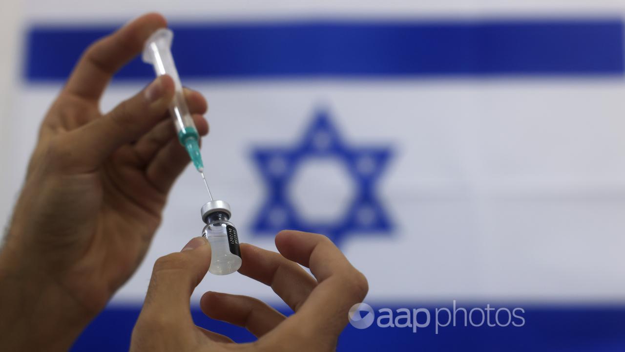 An Israeli paramedic prepares a Pfizer COVID-19 vaccine
