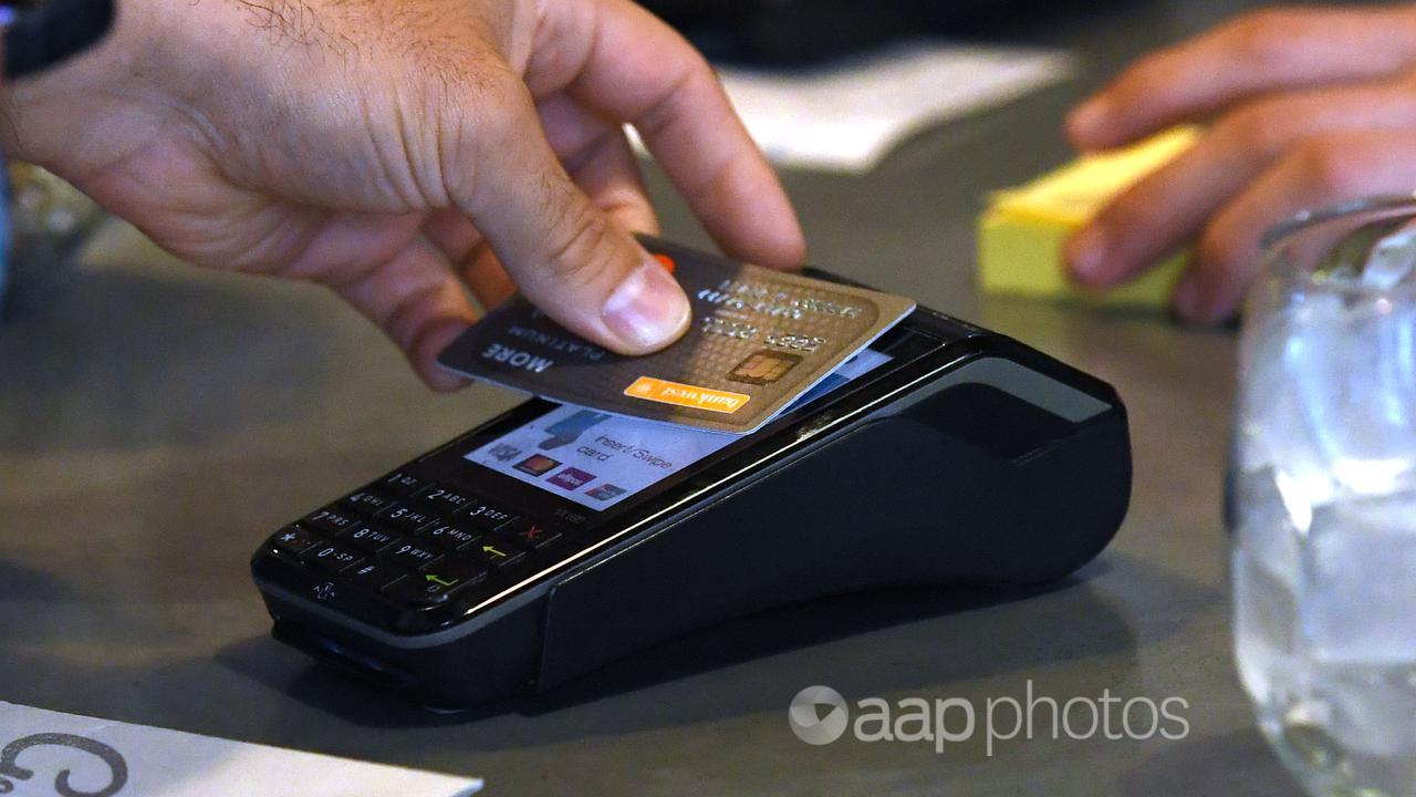 A person making a card payment at a shop.