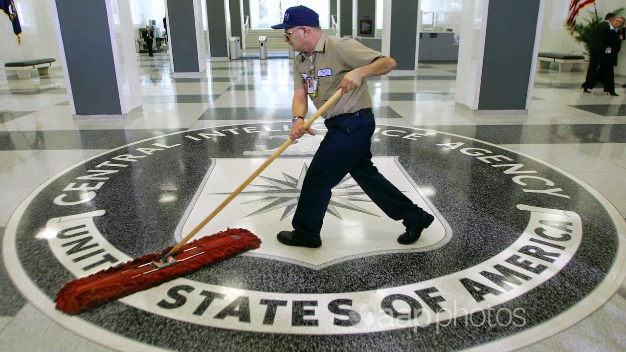 A cleaner sweeps the floor at the CIA's headquarters (file image)