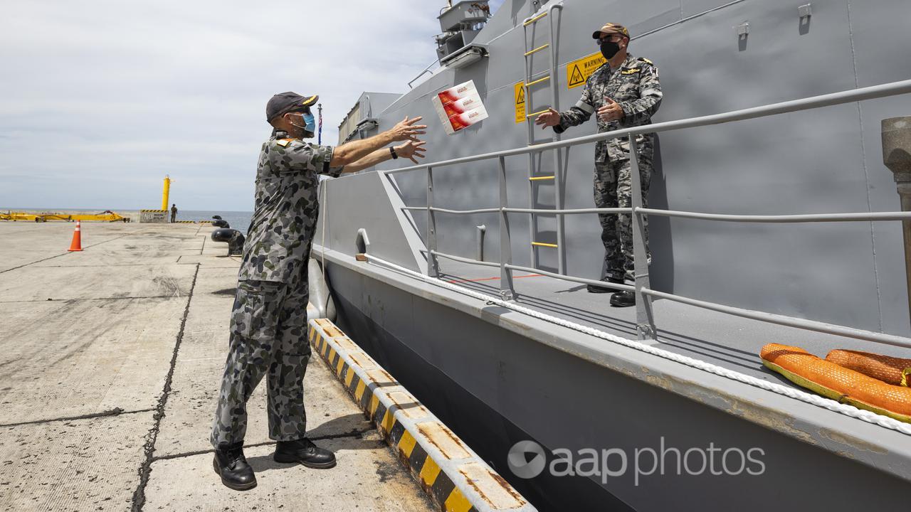 ADF members unload RATs at the Port of Honiara. Pic: Dep of Defence