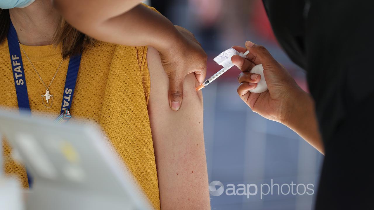 A woman receives a COVID-19 vaccine dose in Melbourne.