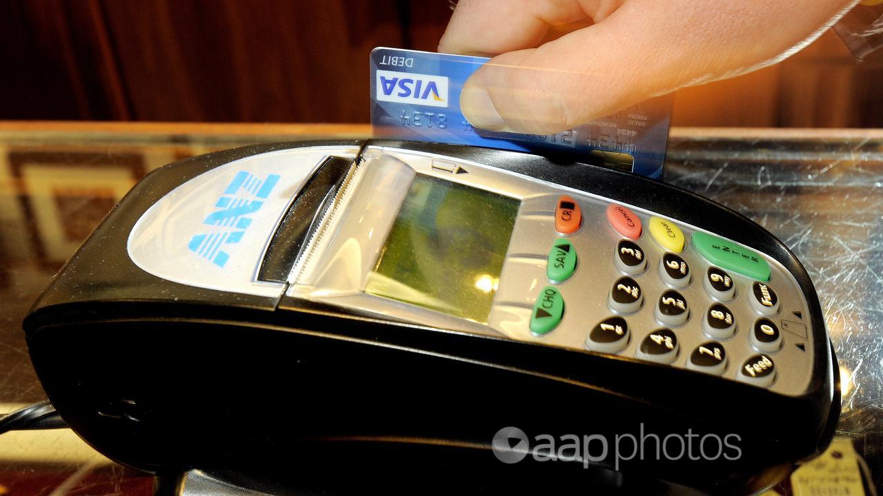 A debit card being used for a transaction.