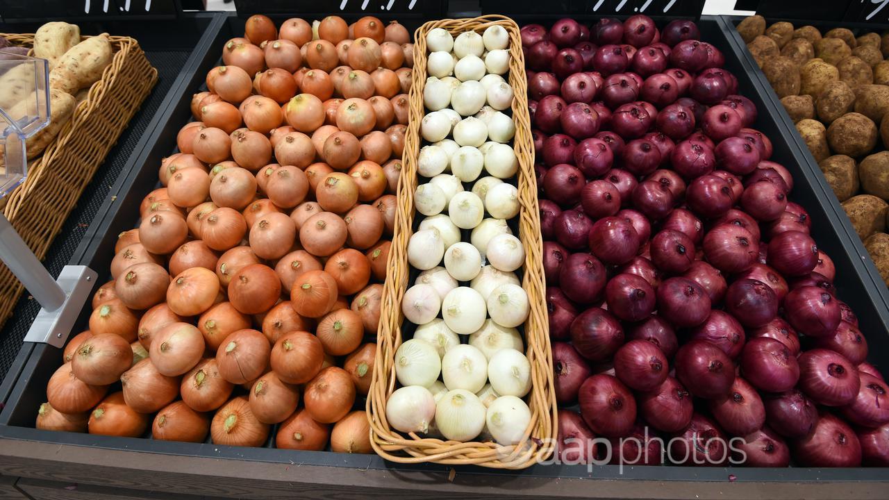 Onions on a supermarket shelf.