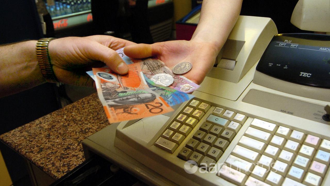 A cash transaction is handled at a store in Canberra.