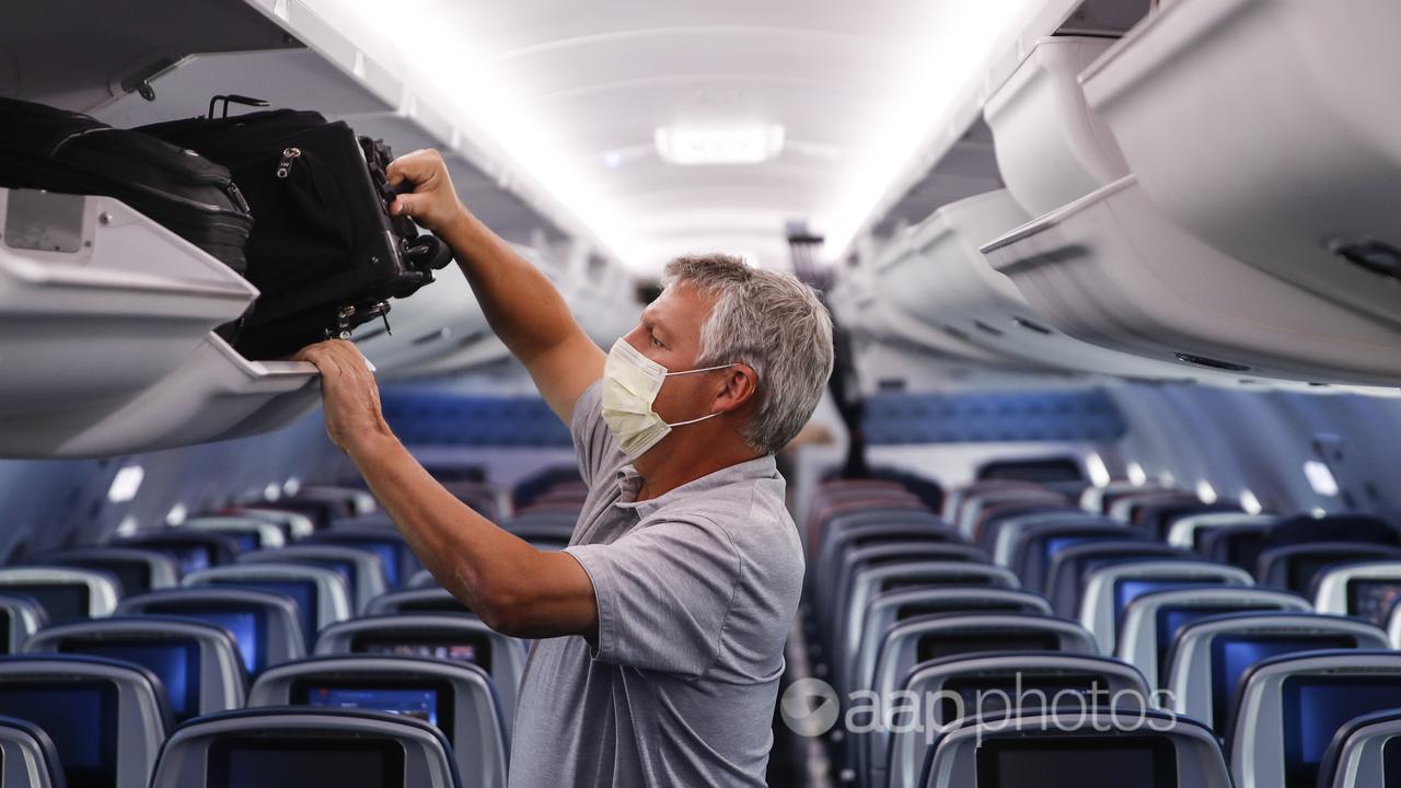 A passenger wears a mask on a flight (file image)