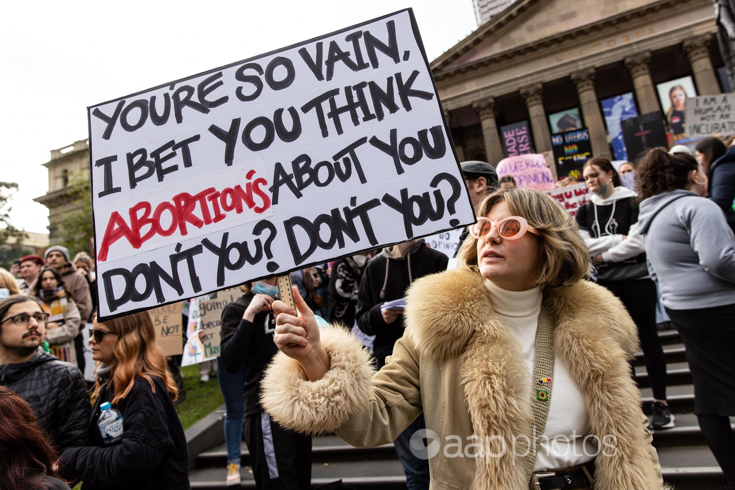 Demonstrators hold placards at a rally in support of abortion rights