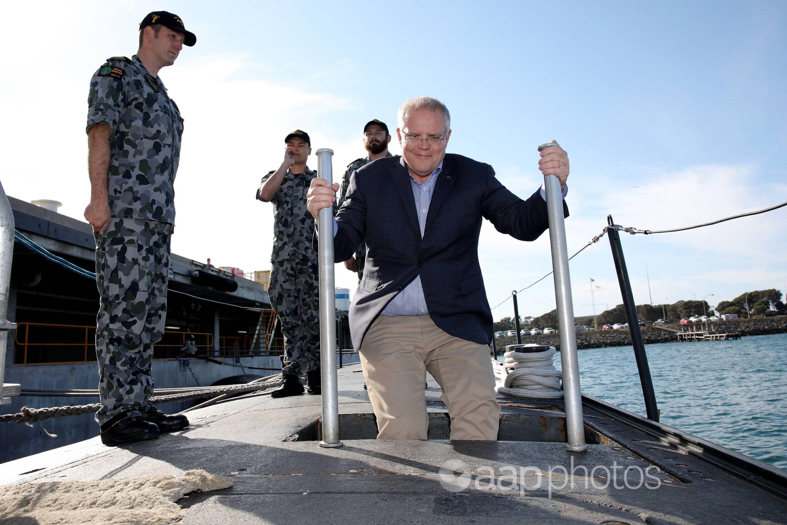 Former prime minister Scott Morrison boarding HMAS Sheean in 2019.