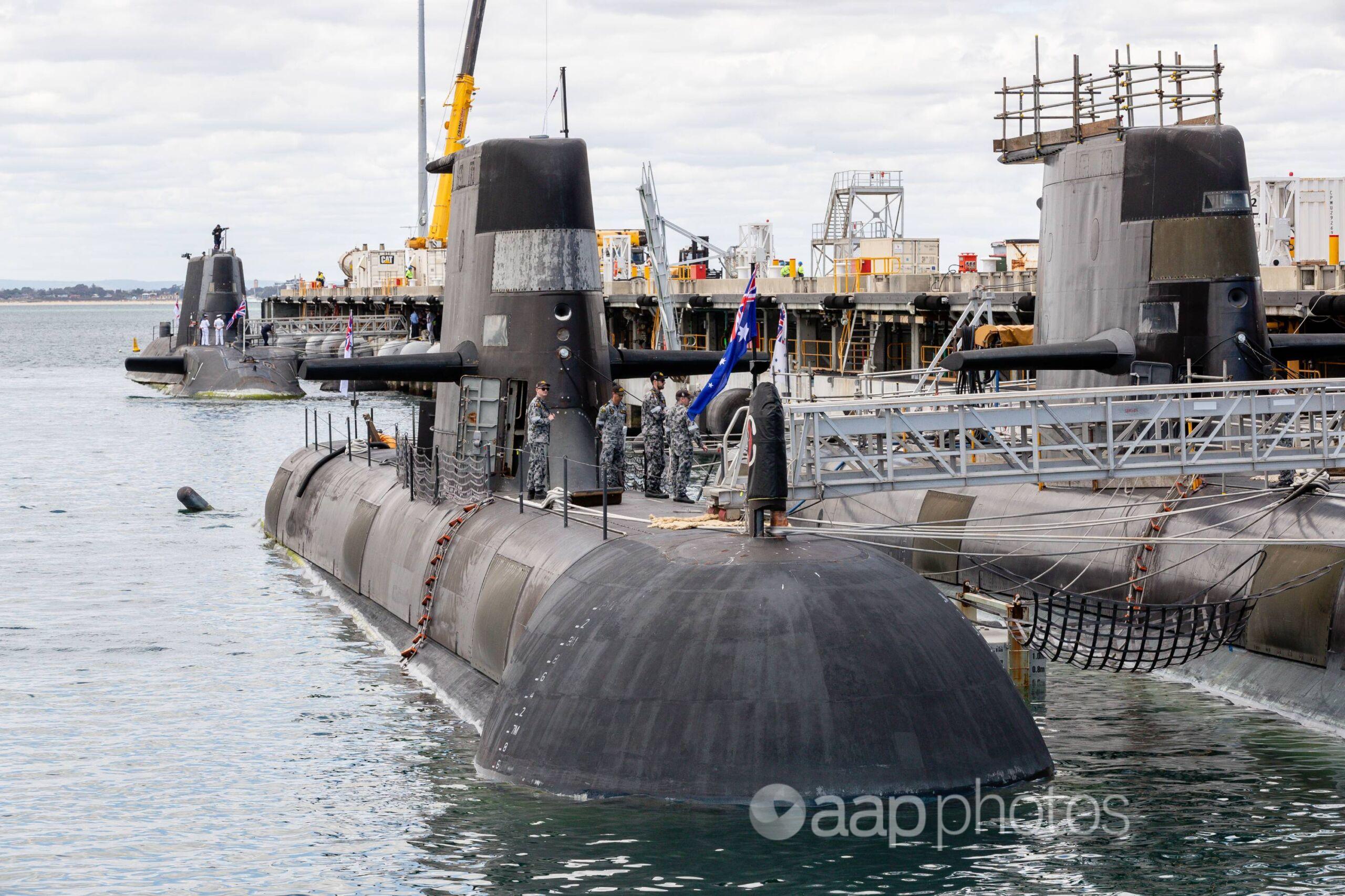 An Australian Collins class submarine (front) at HMAS Stirling, Perth