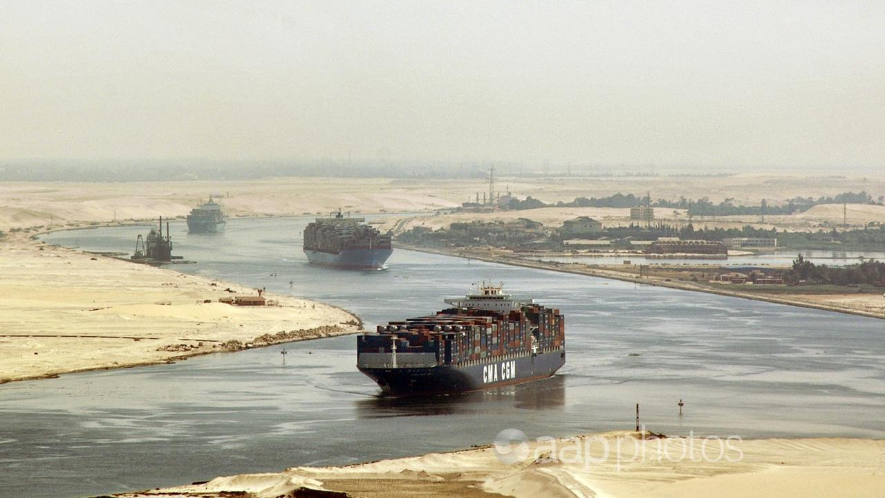 Cargo ships travel through the Suez Canal