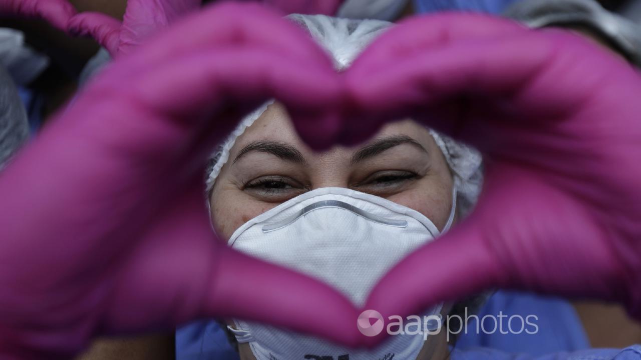 A health worker makes a heart sign (file image)