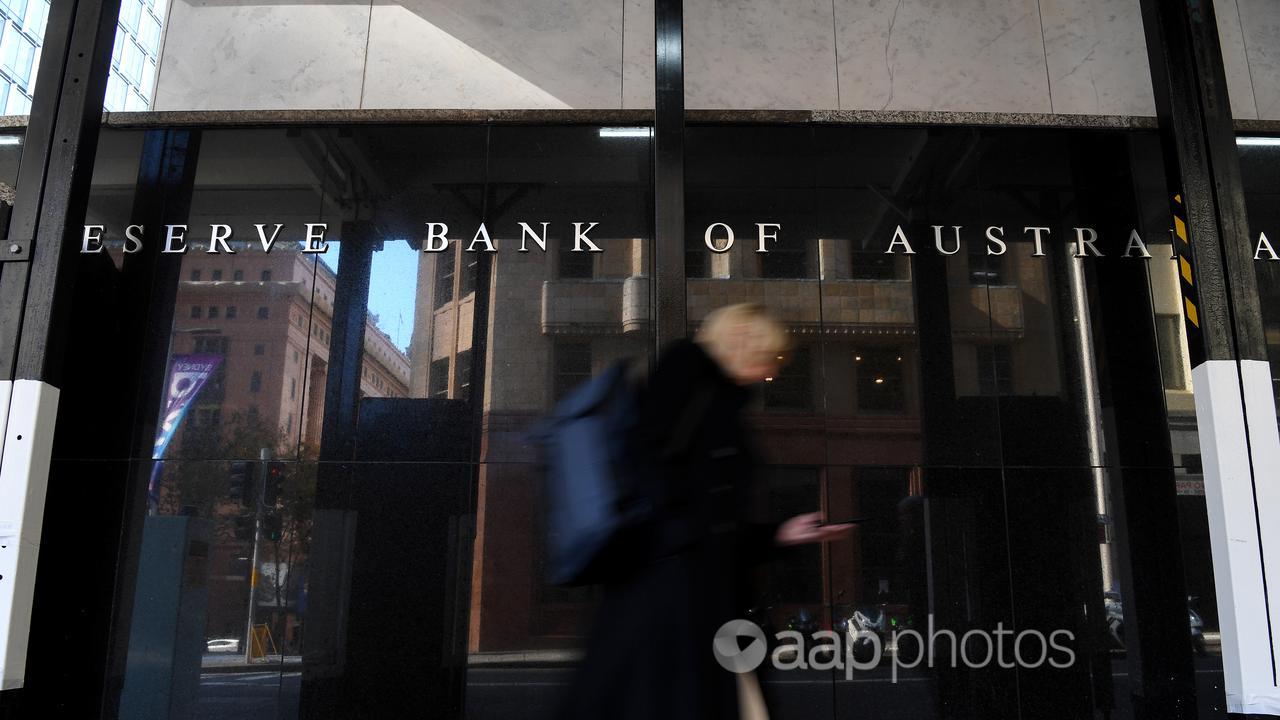 A pedestrian walks past the Reserve Bank of Australia head office