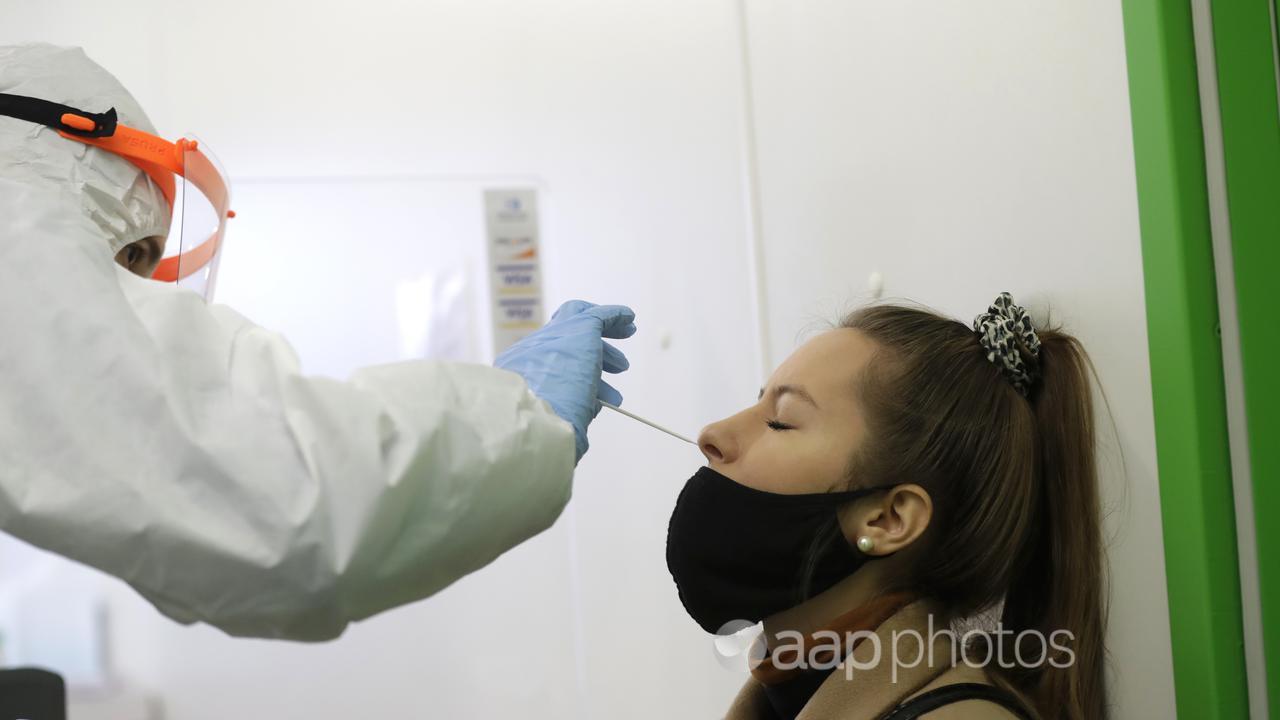 A woman undergoes the rapid antigen test.