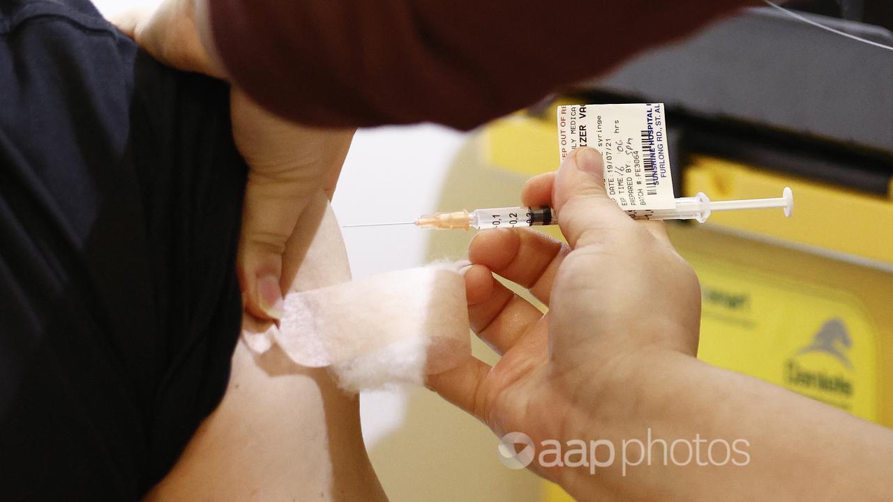 A health worker administers a COVID-19 vaccination (file image)