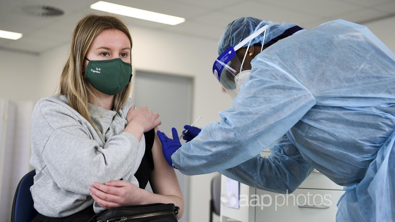 A nurse administers a COVID-19 vaccination.