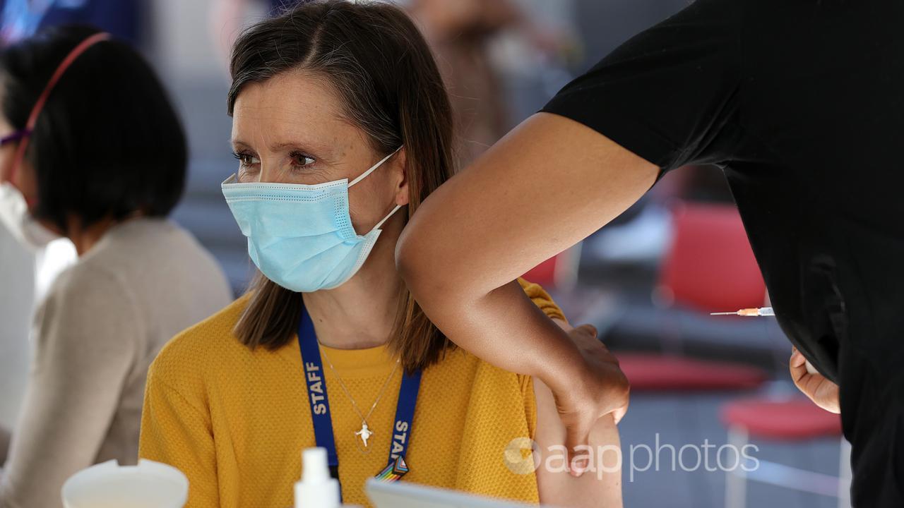 A woman receives a COVID-19 vaccination at the State Library Victoria