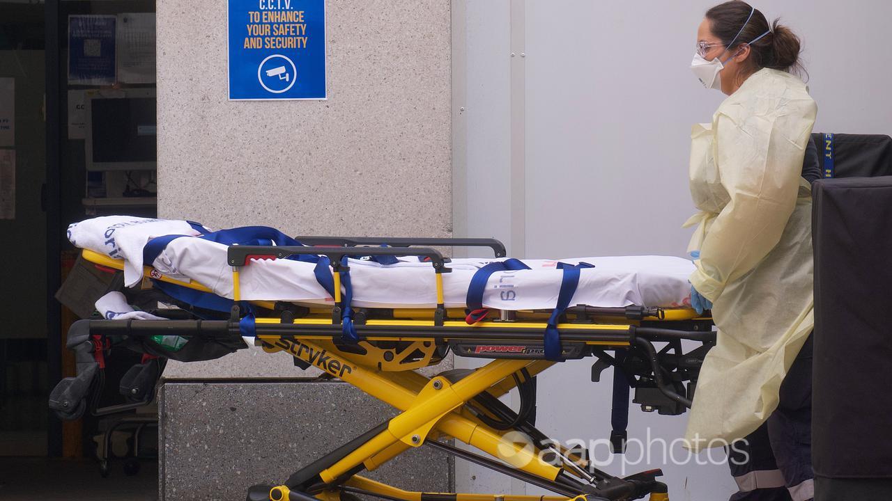 A paramedic with a stretcher outside a Melbourne Hospital.