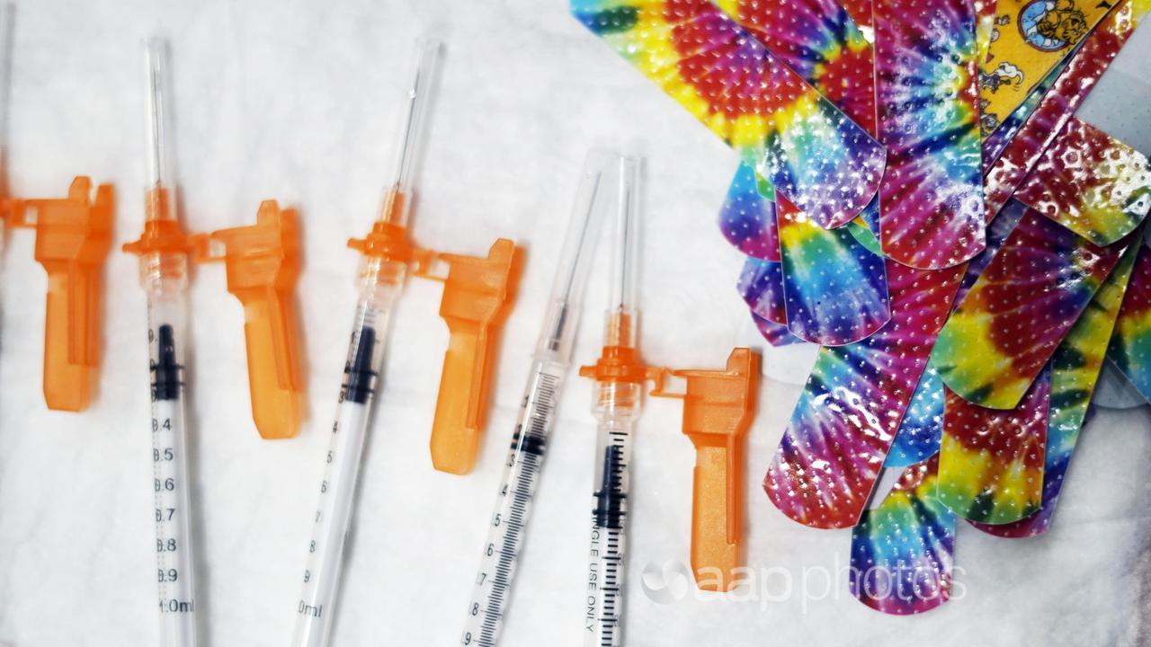 Syringes and colourful bandages.