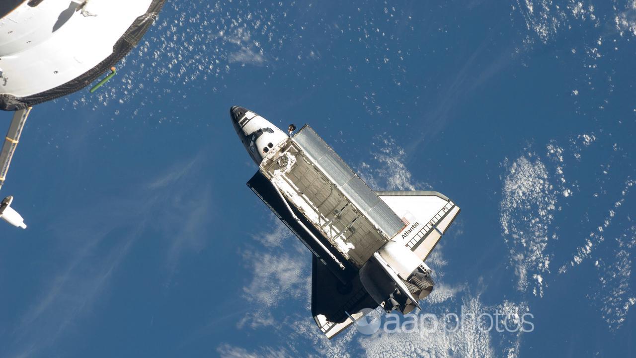 The space shuttle Atlantis over earth in 2009