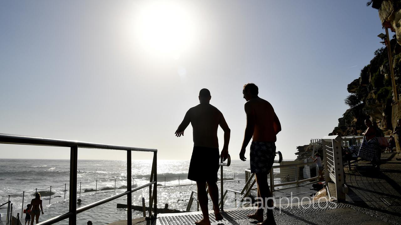 Beachgoers in the sun at Bronte Beach, Sydney