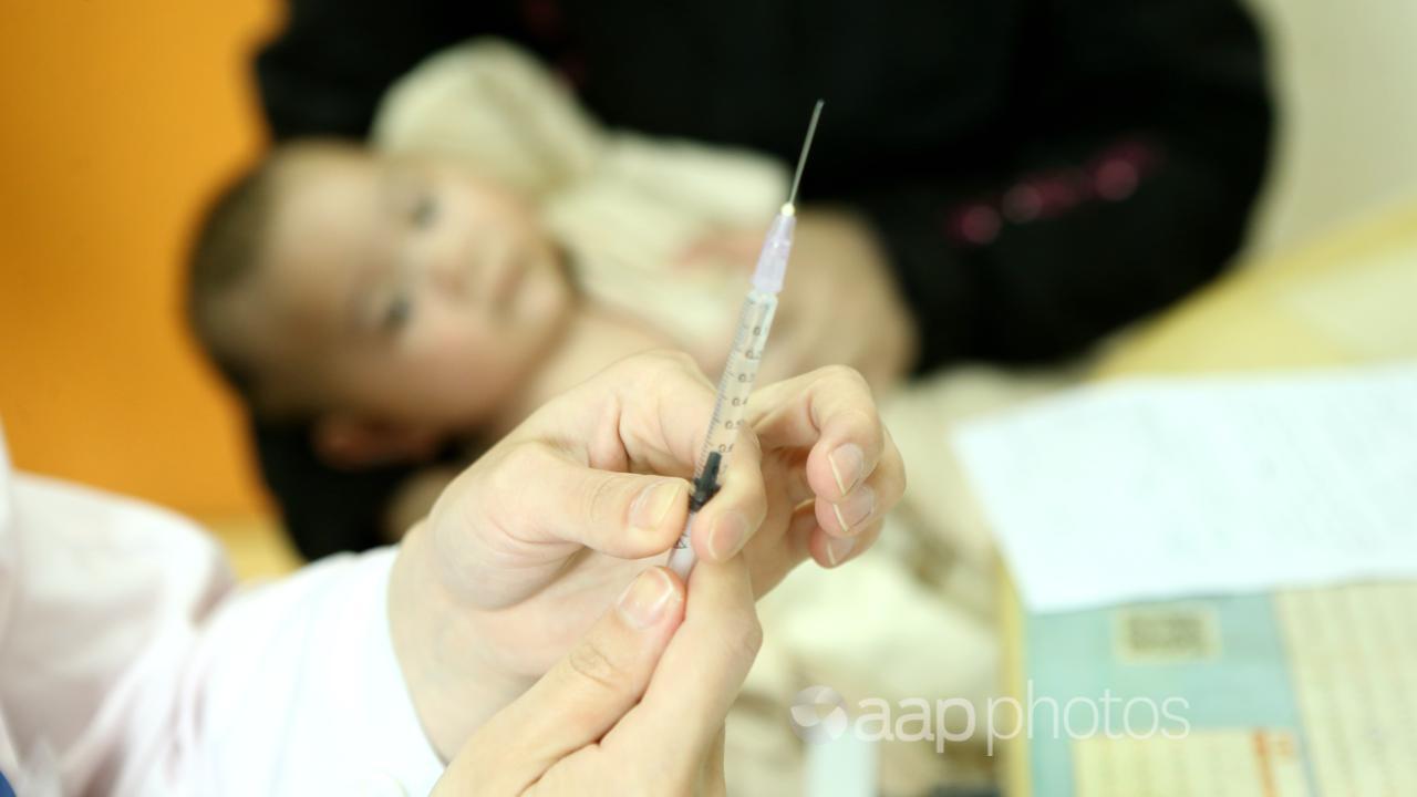 A baby awaits a vaccination