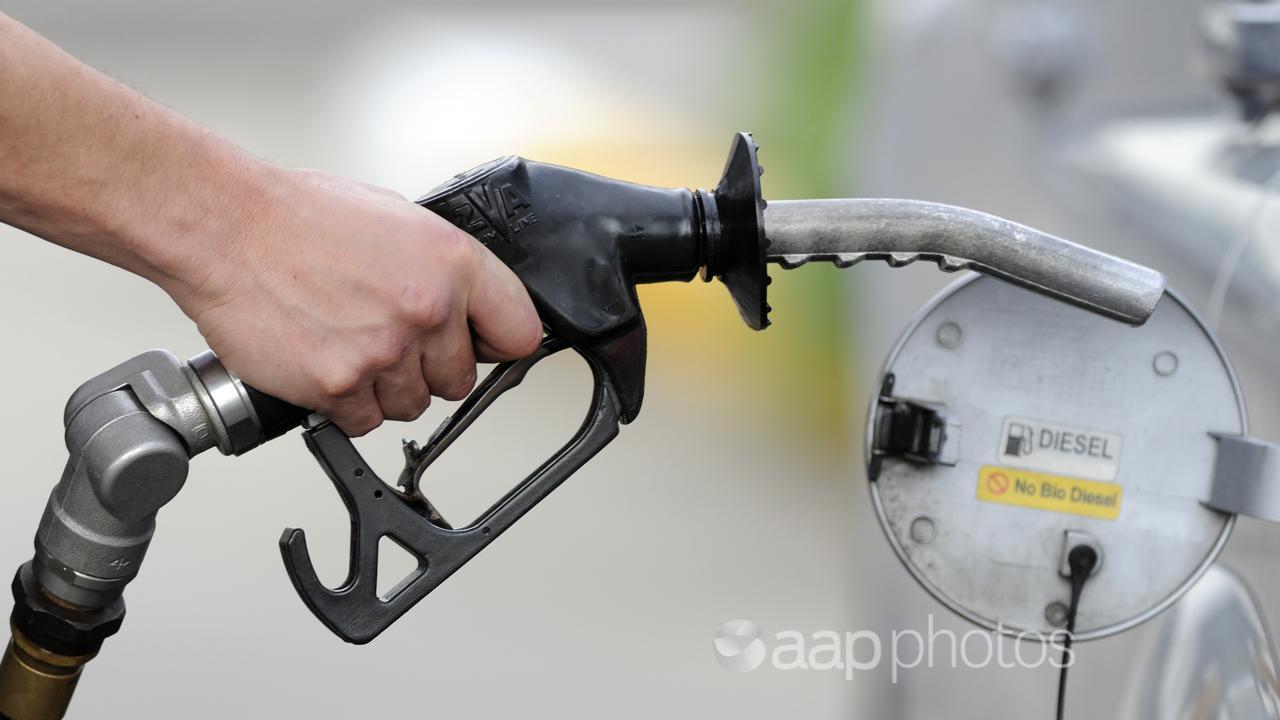 A man pumps petrol at a service station