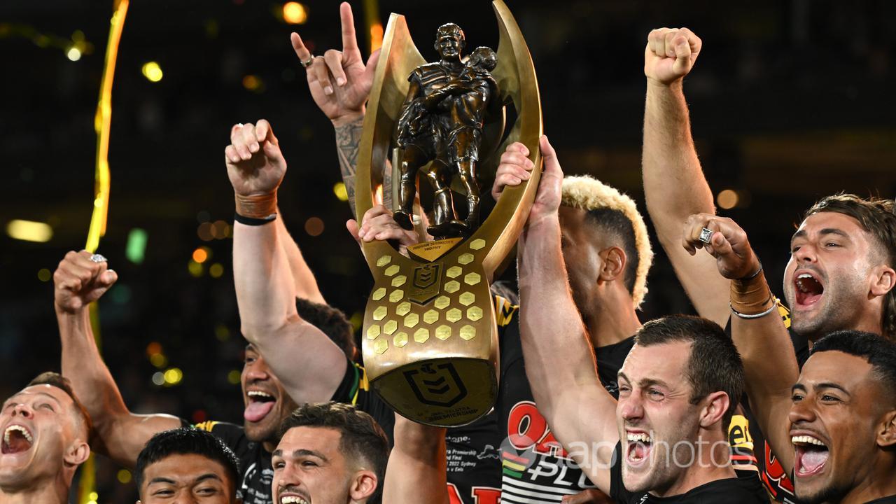 Penrith players lift the trophy after winning the NRL grand final.