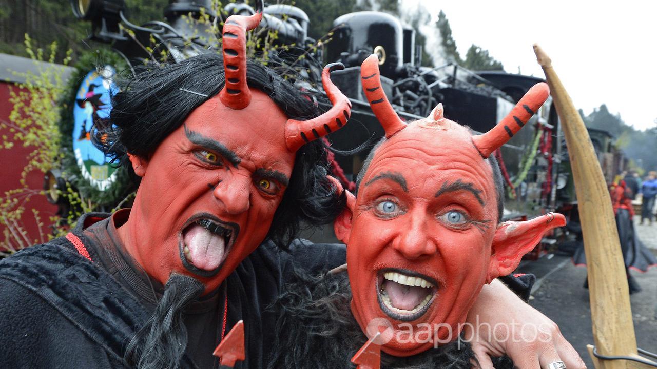 Two men dressed up as the devil