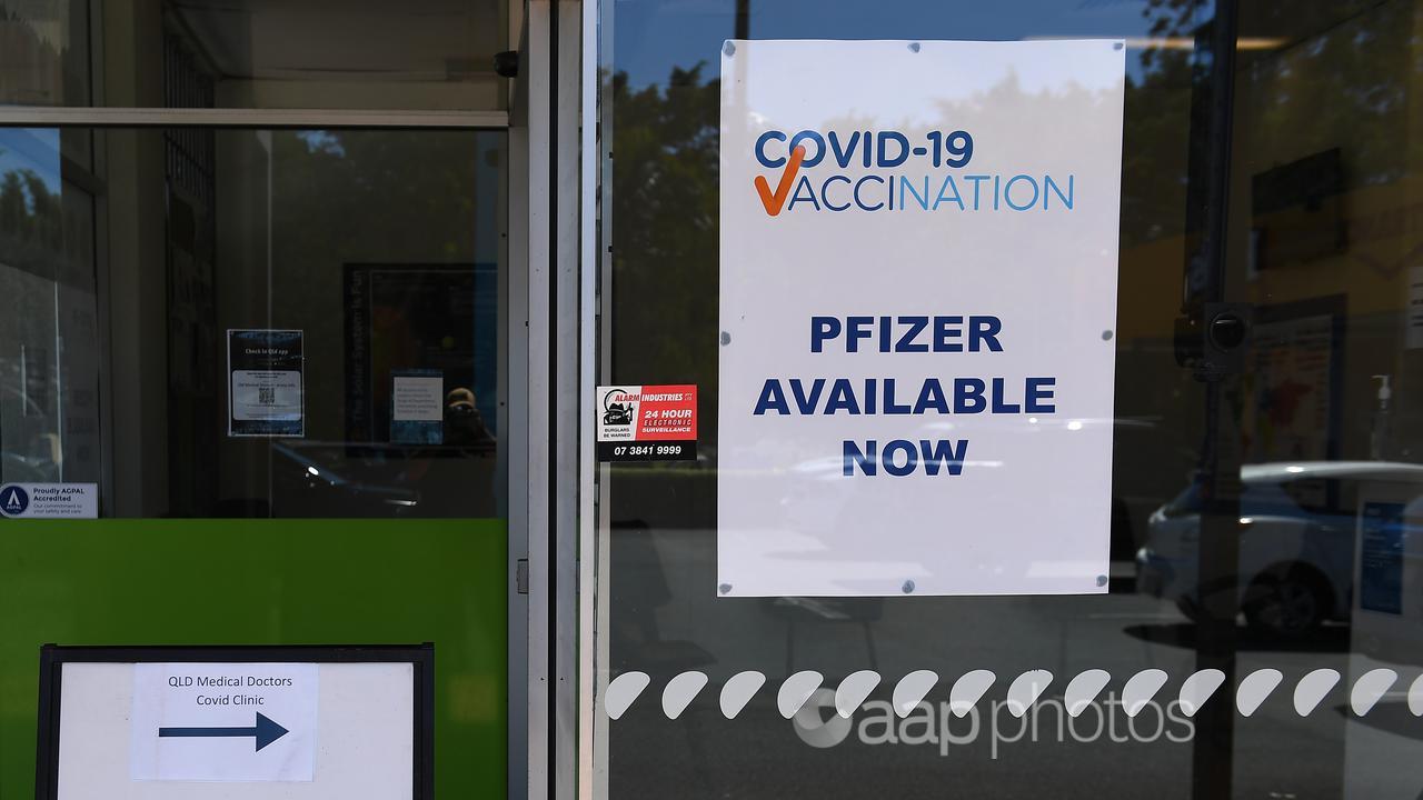 A 'Pfizer Available Now' sign taped to a window (file image)