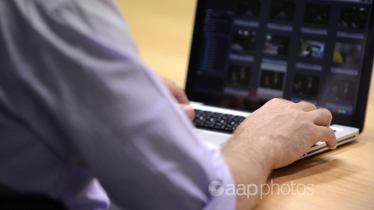 A man uses a laptop computer