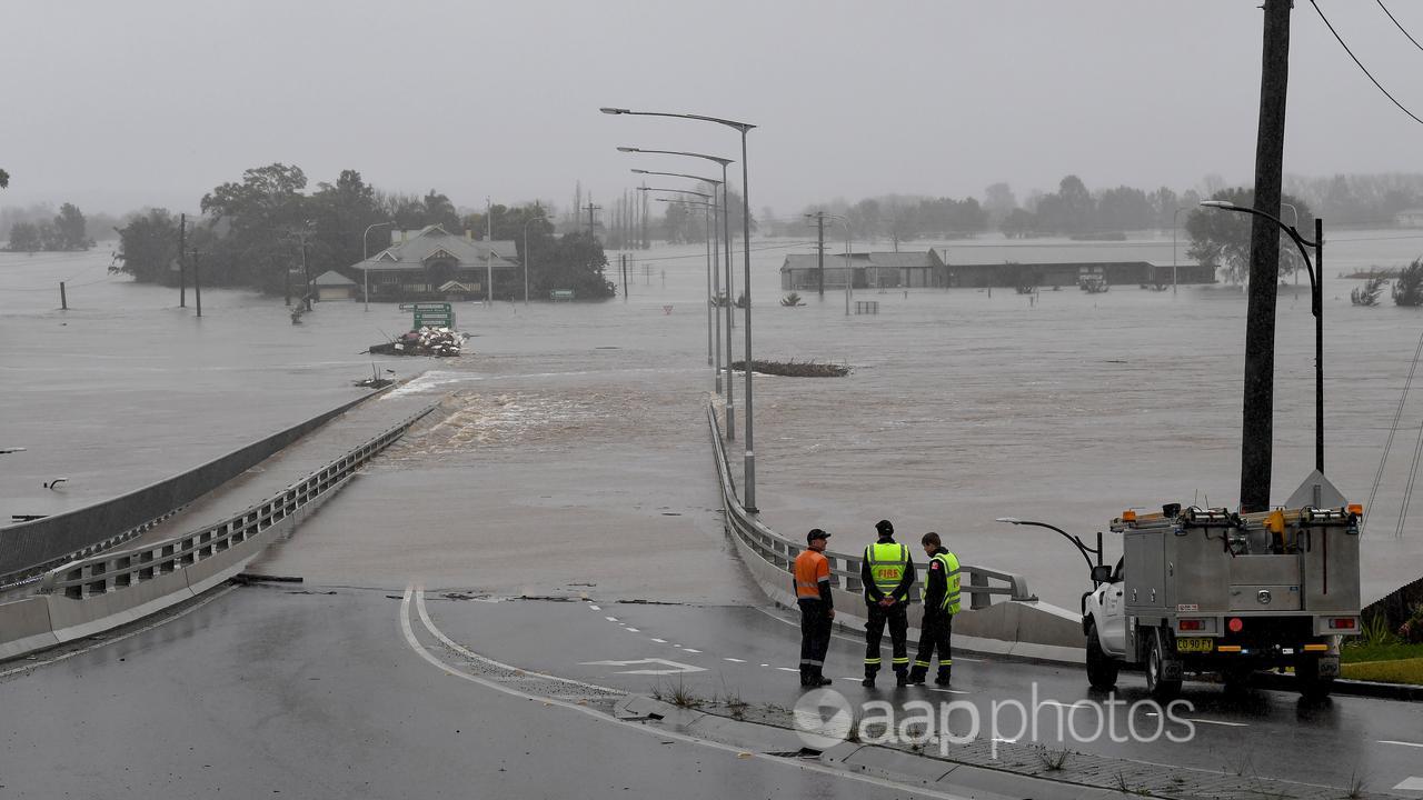 Emergency workers look amid flooding at Windsor, north west of Sydney