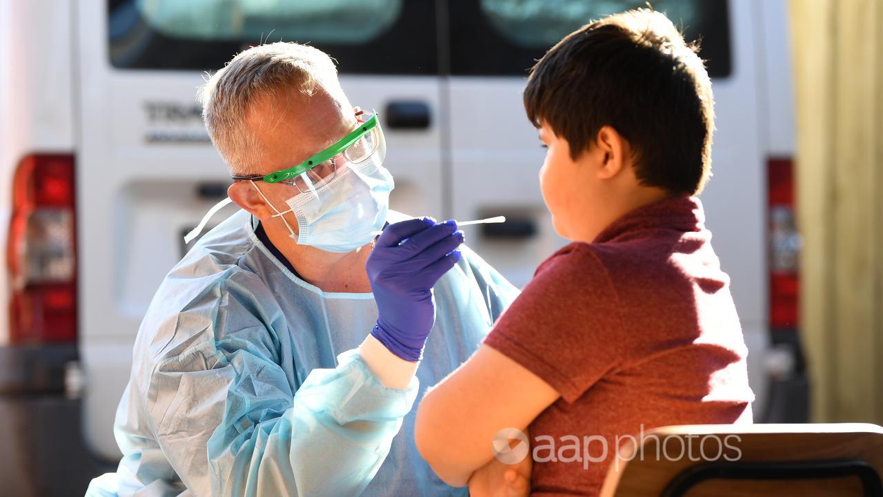 A health worker conducts a COVID test.