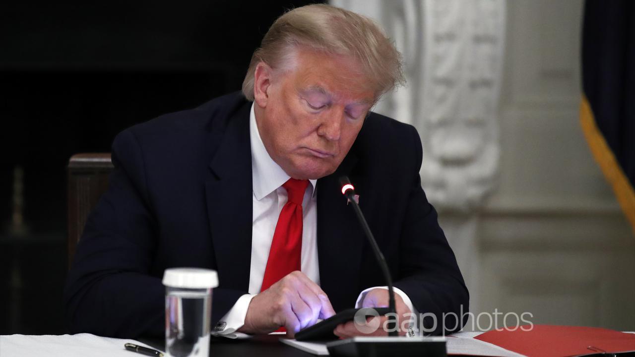 Donald Trump looks at his phone (file image)