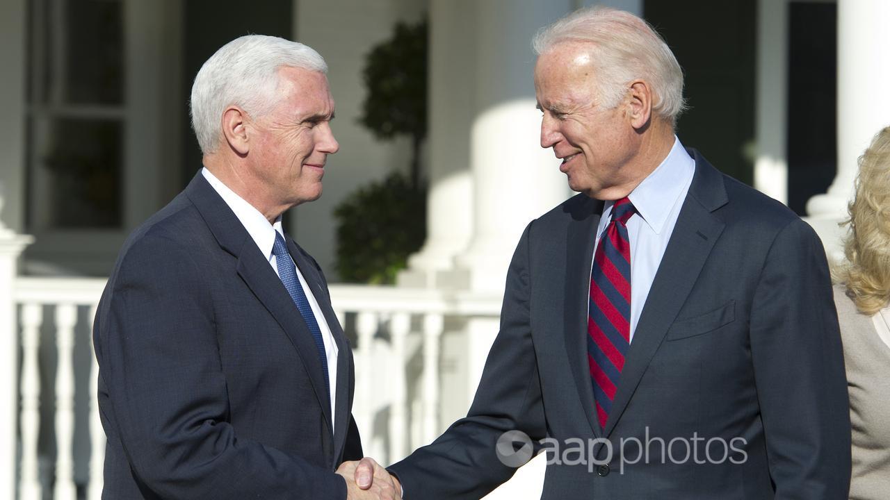 Mike Pence (left) shakes hands with Joe Biden (file image)