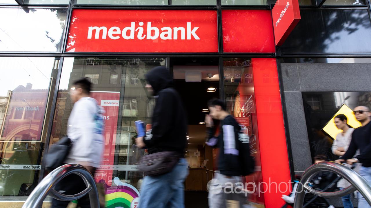 People walk past a Medibank store