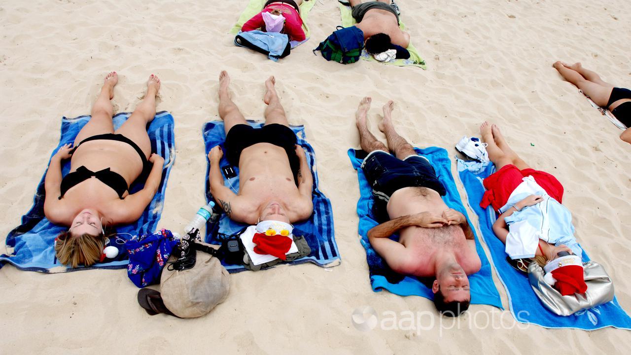 People sunbake at Bondi Beach in Sydney