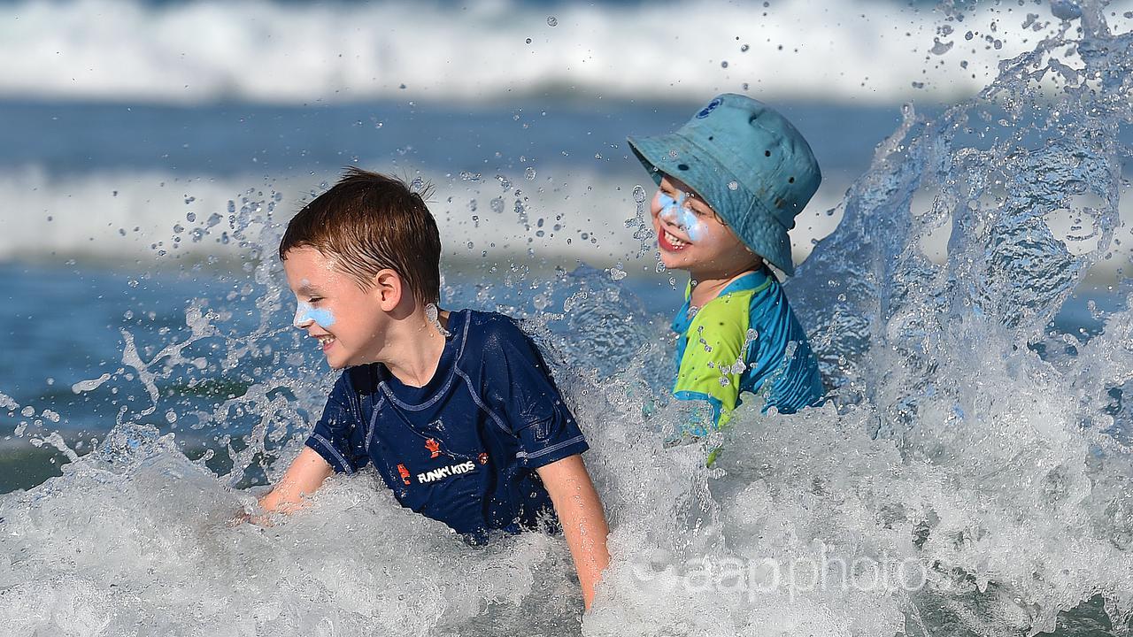 Children play in the ocean (file image)