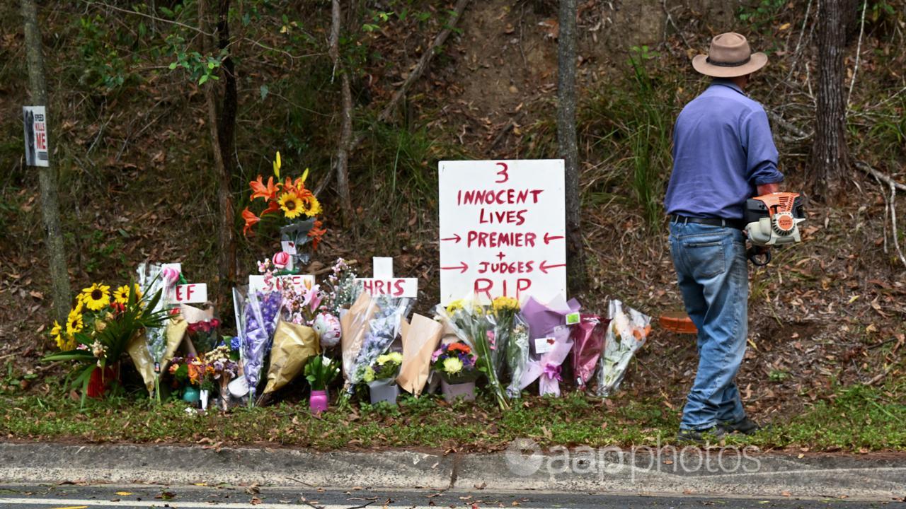 Flowers sit on the side of a road where there was a fatality.