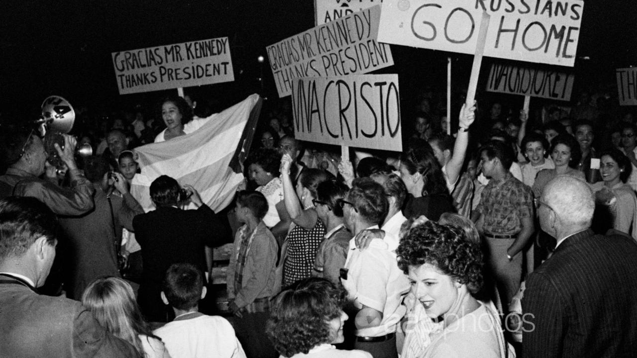 Cubans carrying signs thanking JFK in the aftermath of the Bay of Pigs