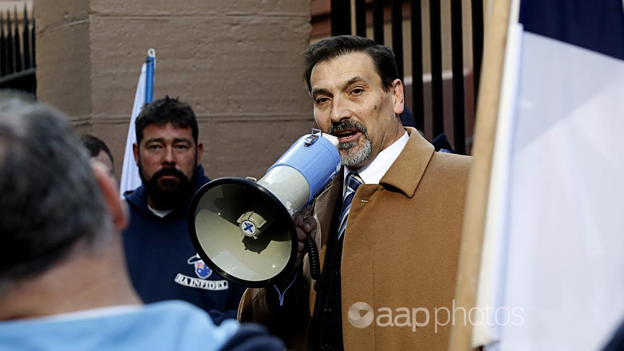 Riccardo Bosi is seen delivering a speech to protesters.