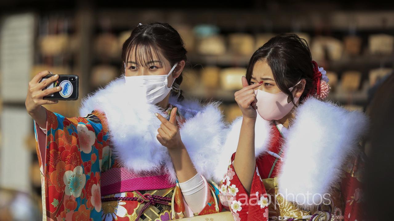 Kimono-clad women wearing face masks (file image)