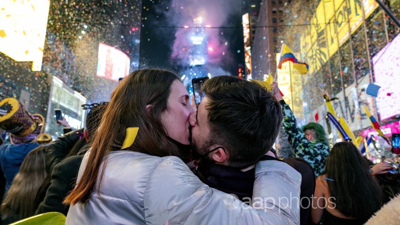 A young couple kiss during New Year's Eve celebrations.