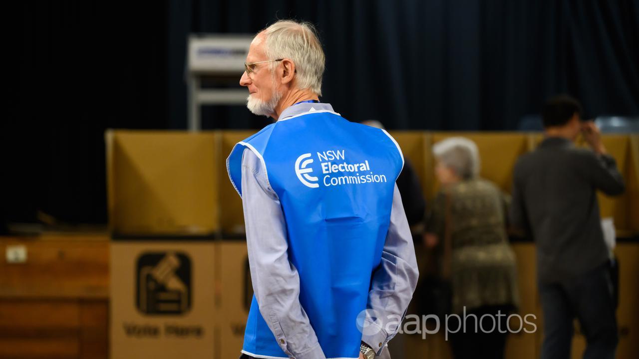 A NSW Electoral Commission staffer oversees a polling centre