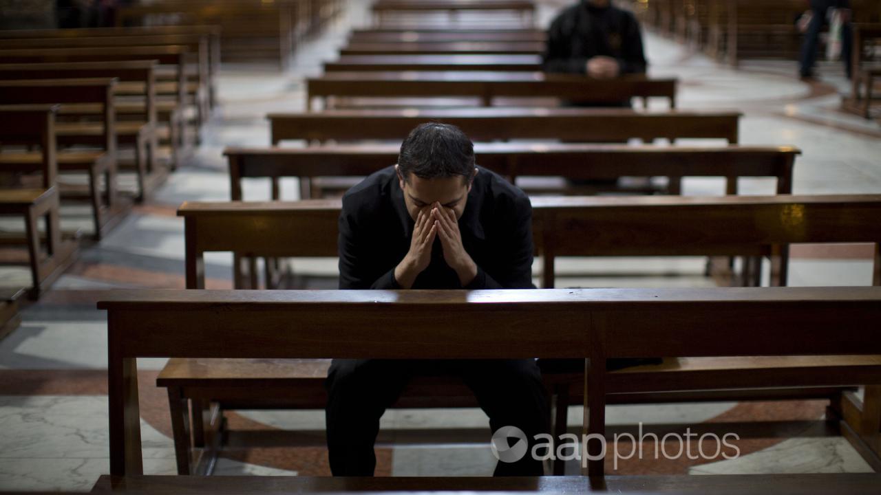 A person prayers inside a church