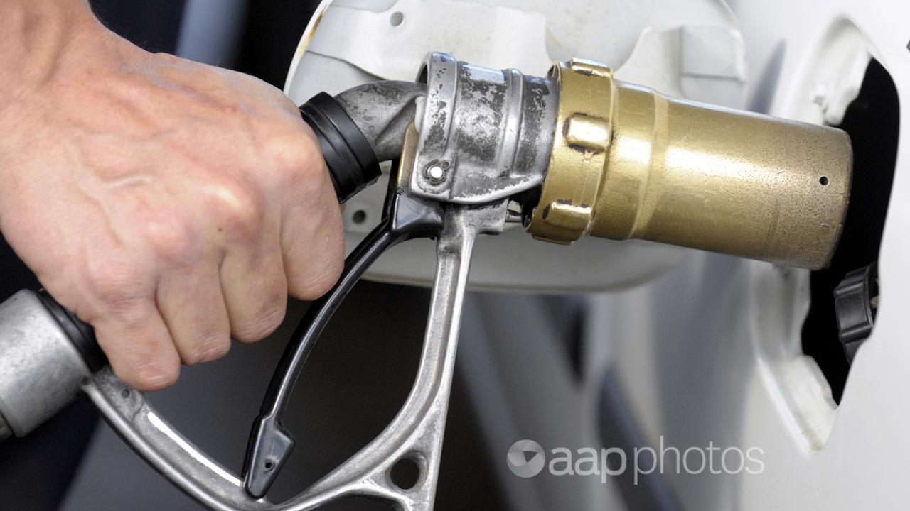 A motorist pumps gas into a vehicle (file image)